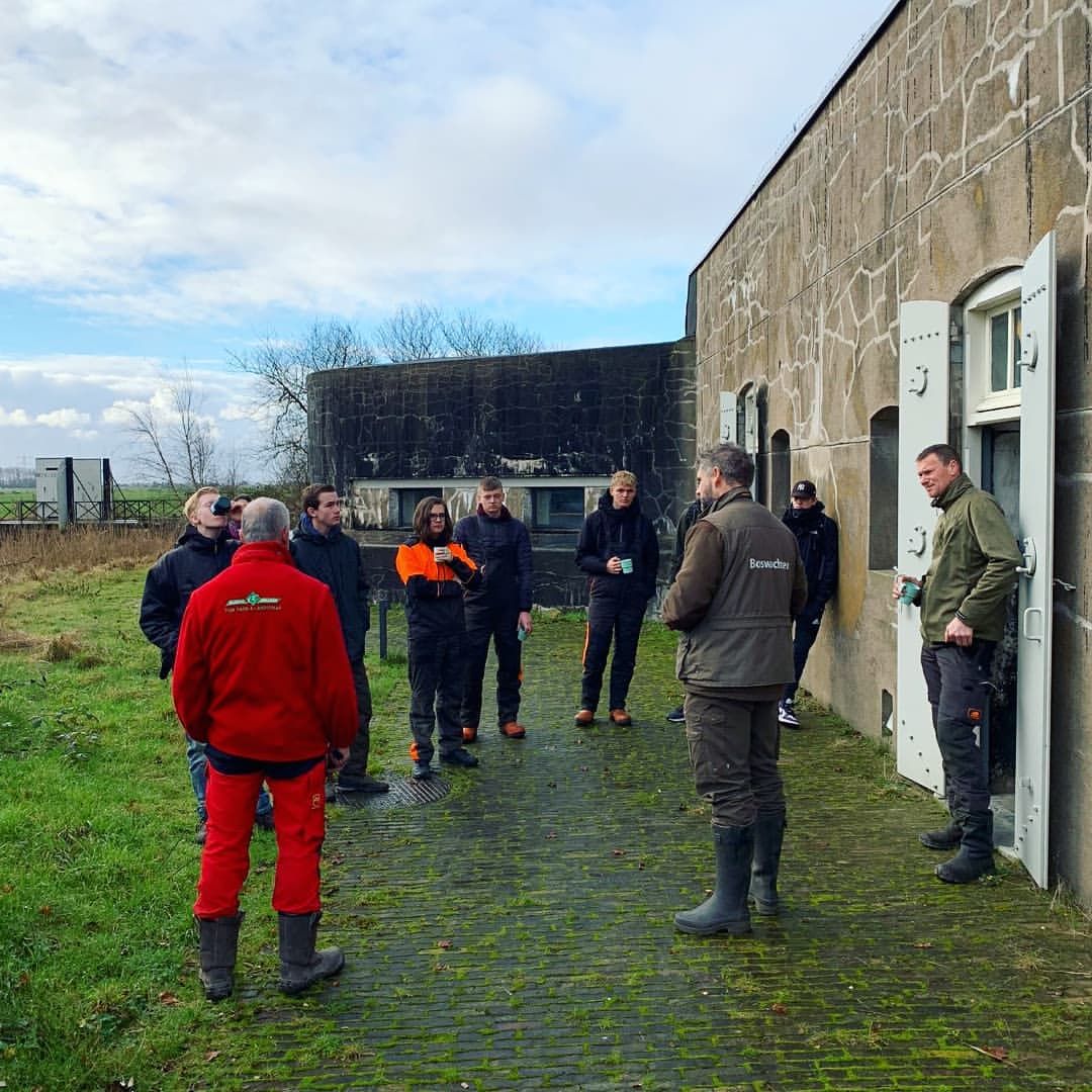 Leerlingen staan buiten te luisteren naar uitleg 